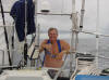 Marquesas Passage - Jan showering at the stern - 73K