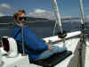 Signe enjoying the sun on the bow as we travel (61K)